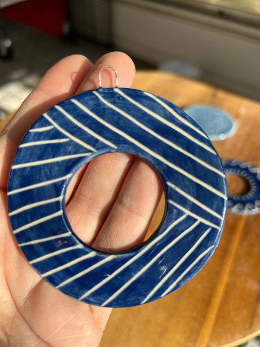 Hand-carved blue ornament with line detailing