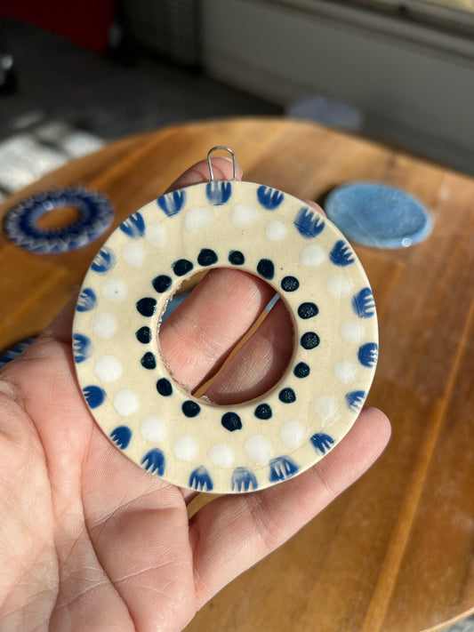 Circle ornament with blue and white designs